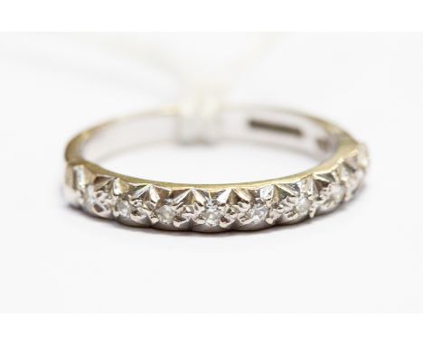 A diamond half set eternity ring, white metal (possibly 18ct white gold) set with nine small diamonds, size M, total gross we