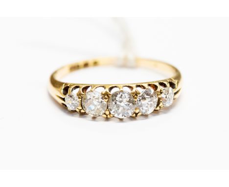 A diamond five stone 18 carat yellow gold ring, the boat shaped head containing five round old-cut diamonds, calculated total