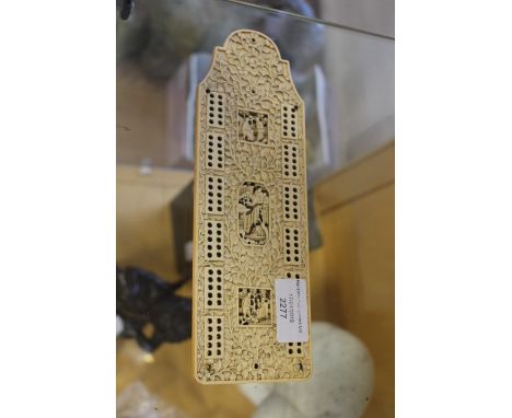 A Chinese pre 1947 ivory cribbage board, carved with typical scenes