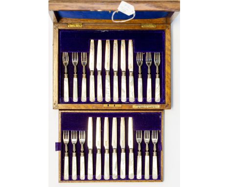 A boxed set of twelve place setting silver fruit knives and forks with mother of pearl handles, blades and tines all hallmark