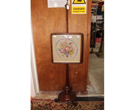 An early Victorian rosewood pole screen, woolwork panel, platform pedestal base