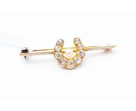 A diamond and seed pearl yellow gold bar brooch, the central   horseshoe bead set with a total of nine old cut diamonds, tota