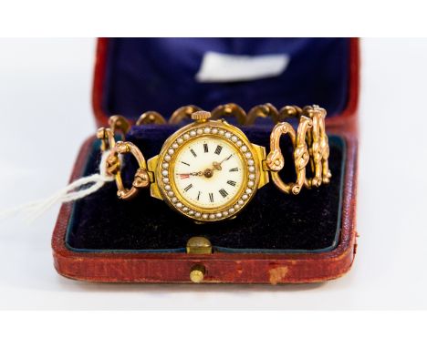 Edwardian 9ct gold lady's wristwatch with enamelled dial with seed pearl set bezel, enamel dial (lacking glass), Roman numera
