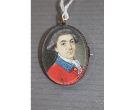  A George III oval portrait miniature pendant, circa 1790, a gentleman, bust length, wearing a red tunic with a blue collar a