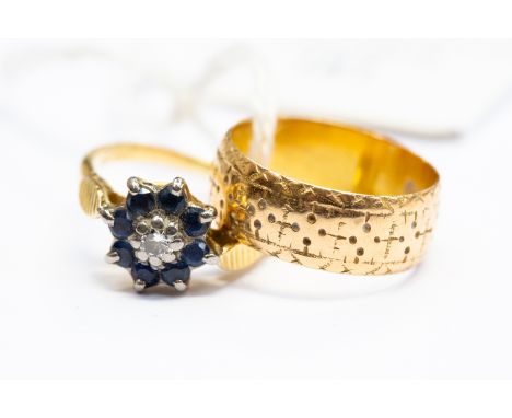 An 18ct gold band, 5.3 grams approx; together with a sapphire and central diamond ring, size M (2) 