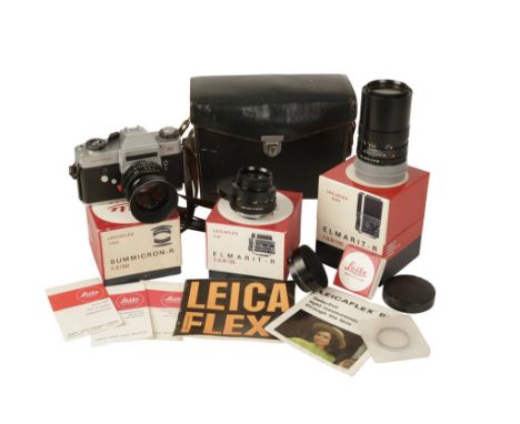 A LEICAFLEX SL CAMERA with three spare lenses, Summicron-R 1:2/50 two Elmarit-R 1:2.8/135, in original case and manual circa 