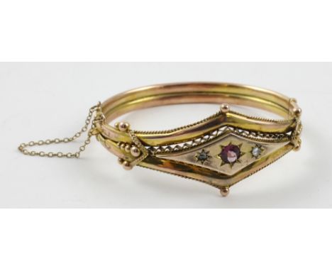A Victorian garnet and chip diamond set 9ct yellow gold hinged bangle, width 6cm, approx 13g.
