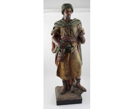 A late 19th century Austrian-style terracotta cold-painted Orientalist figure in the manner of Goldscheider, modelled as a Mi