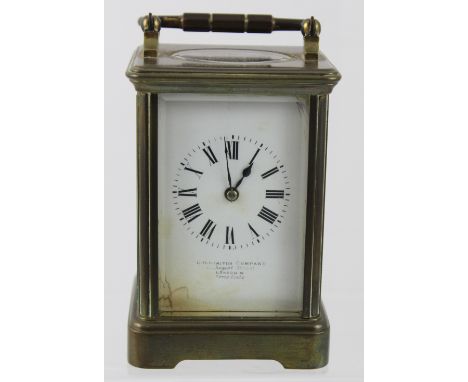 A Goldsmiths Company of Regent Street London brass carriage clock, enamelled dial set with Roman numerals, height 12.5cm. CON