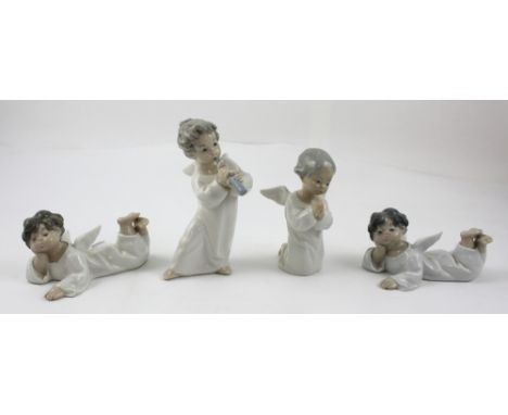 Four Lladró angel figures in various poses to include one at prayer and one playing the flute (4).