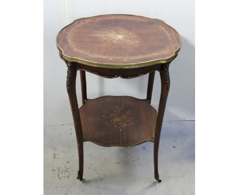 A French style kingwood marquetry serpentine occasional table adorned in gilt brass with tapering cabriole legs untied by a s