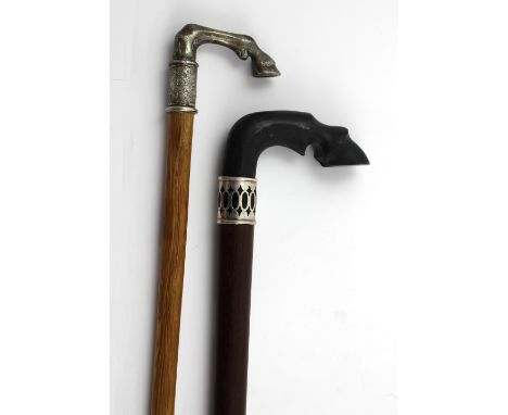 A heavy hardwood equestrian walking stick with carved horn fetlock handle, length 92.5cm and a smaller ash cane with similar 