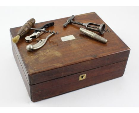 An early 20th century mahogany jewellery box lined with green floral fabric containing three vintage corkscrews, one cased ex