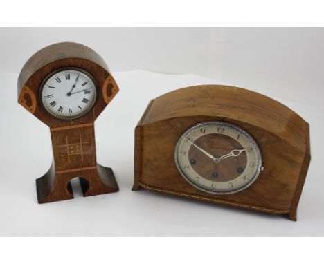 An early 20th century Arts and Crafts oak-cased mantel clock, copper banded decoration, white ceramic dial set with Roman num