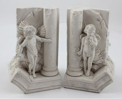 A pair of plaster Classical style bookends, Greek columns with putti playing hide and seek, impressed marks R.C.A., height 18