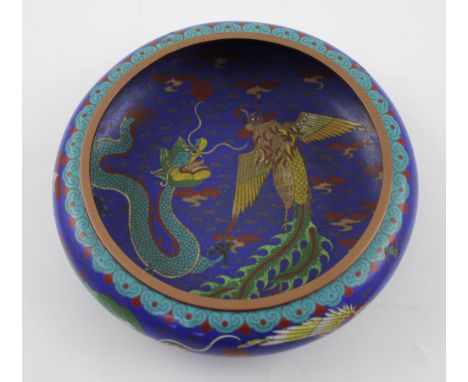 A Japanese cloisonné bowl, electric blue ground with dragon and mythical bird decoration, diameter 25cm. CONDITION REPORT Two