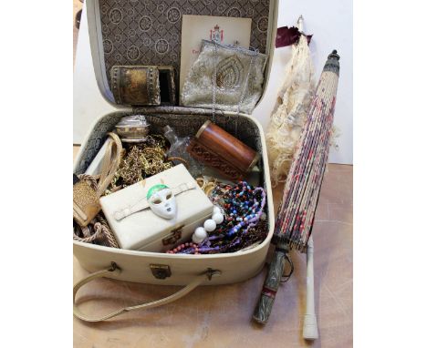 A vintage vanity case containing a quantity of costume jewellery to include brooches, necklaces, earrings and various vintage