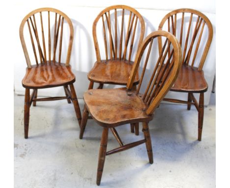 A set of four Windsor stick back dining chairs with bent oak hooped back over elm seat supported on four turned beech legs un