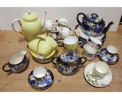 A Doulton Burslem Japanese style tête-à-tête tea service comprising two cups and saucers, sucrier, teapot and milk jug, gilt-