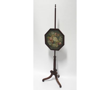 A 19th century mahogany pole screen with floral tapestry screen in an octagonal frame, to turned column and tripartite suppor