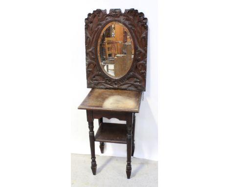 An early 20th century carved oak elliptical wall mirror, 71.5cm x 55cm and an Edwardian stained pine Arts &amp; Crafts style 