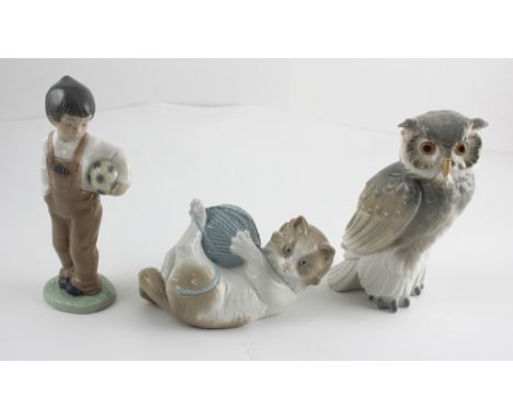 Three Lladró Nao figures to include long-tufted screech owl, kitten with ball of wool and a small boy with football under his