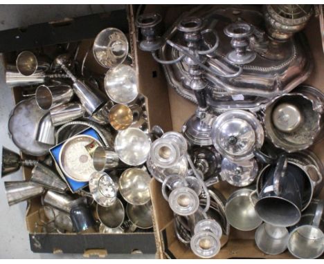 A large quantity of plated, pewter and white metalware to include a pair of three-branch candelabra, wine goblets, entrée dis