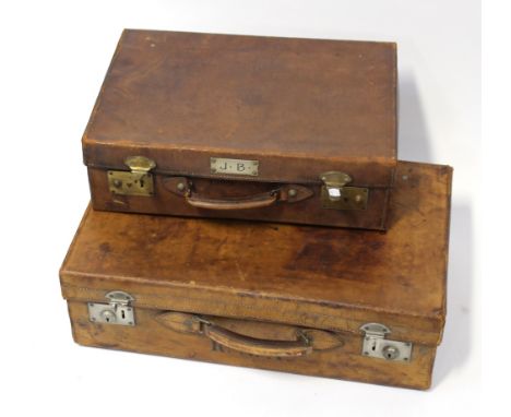 Two early 20th century suitcases, an 'Army &amp; Navy Co-op Society, London' example with travel labels, length 61cm and a le