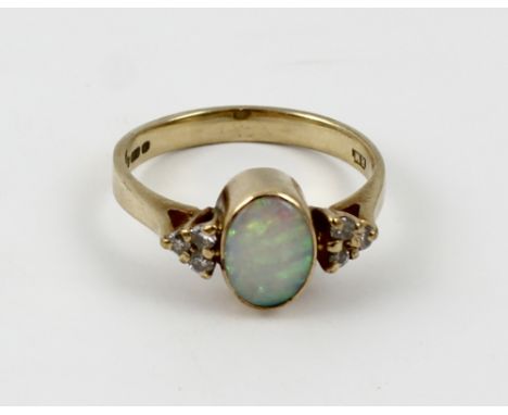 A 9ct gold white opal solitaire ring with triple chip diamond set shoulders, size M 1/2, approx 2.5g.