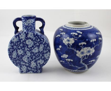 An early 20th century Oriental blue ground ginger jar with prunus blossom decoration, character marks to the base, lacking co