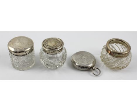 Three cut glass dressing table trinket pots with hallmarked silver collars and tops and a hallmarked silver full hunter watch