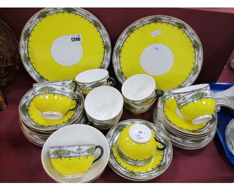 XX Century Royal Worcester Tea Service, patterned with a band of flowers on a yellow ground, puce mark to base.