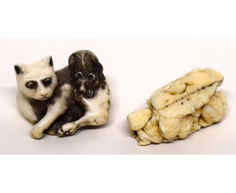 Two finely carved netsuke, one of a cat with a rat on its back