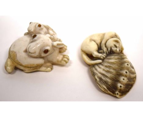 Two finely carved netsuke, in the form of a pair of rabbits