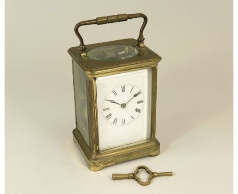 CARRIAGE CLOCK. A 20th century brass carriage clock with key.