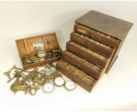 WATCHMAKER'S EQUIPMENT ETC. A pine cabinet of five graduated drawers, each containing a large quantity of watch & clock cryst