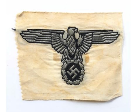 German Third Reich. SS silver wire eagle and swastika from car pennant.A fine rare rayon Bevo machine embroidered SS silvered
