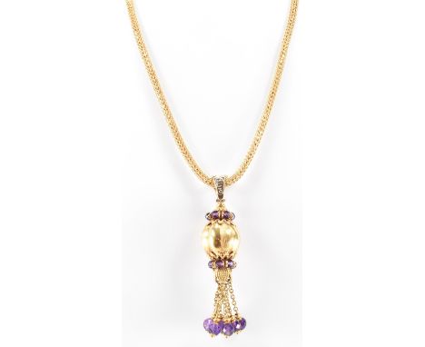 A vintage gold and amethyst pendant necklace. The necklace having a round mesh chain with an orb pendant suspended below with