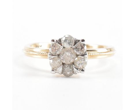 A gold and diamond cluster ring. The ring being set with a cluster of seven round brilliant cut diamonds. Marked 585 / 14ct t