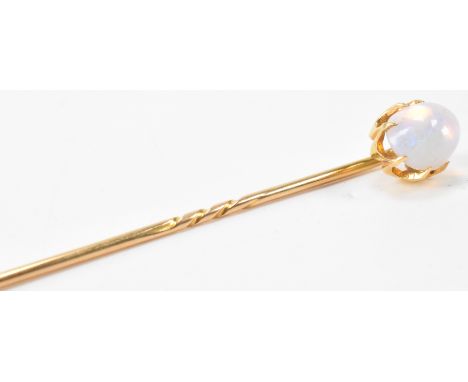 An opal and gold stick pin. The pin having a claw mounted opal to gold stick pin. The opal cabochon&nbsp; exhibiting mostly b