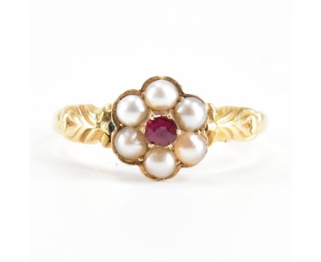 A 19th Century Victorian hallmarked 18ct gold ruby and seed pearl ring. The ring having a central round cut ruby surrounded b