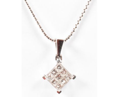 A hallmarked 18ct white gold and diamond pendant. The necklace strung with a diamond set pendant to fine snake chain. Hallmar