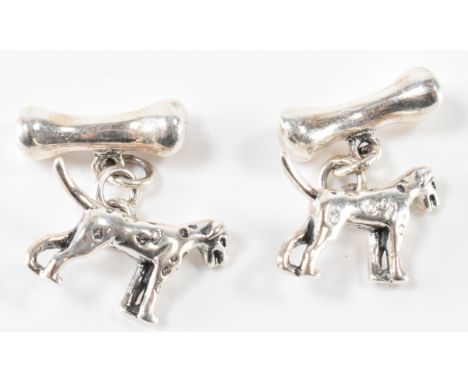 A pair of silver gents dog and bone cufflinks attached by chain bar. marked 925 to underbelly. Measures 22mm. Total weight 11