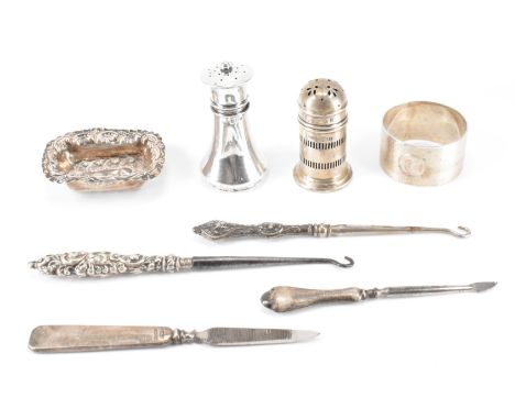 A group of silver hallmarked antique items. The lot to include a selection of button hooks with silver hallmarked handles, a 