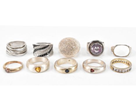 An assortment of ten silver stones set and dress rings. The lot to include a textured dome ring, amethyst dress ring, half et