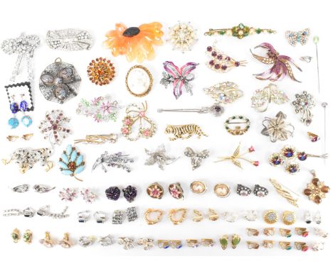 An assortment of vintage brooches and clip on earrings. The lot to include rhinestone, enamelled, filigree a leopard brooch a
