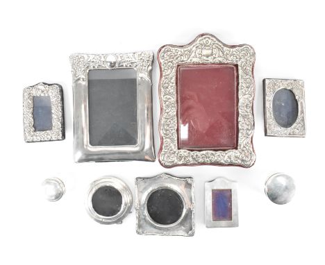 An assortment of 19th century Victorian and later silver hallmarked photo frames and vanity pots to include an Edwardian phot