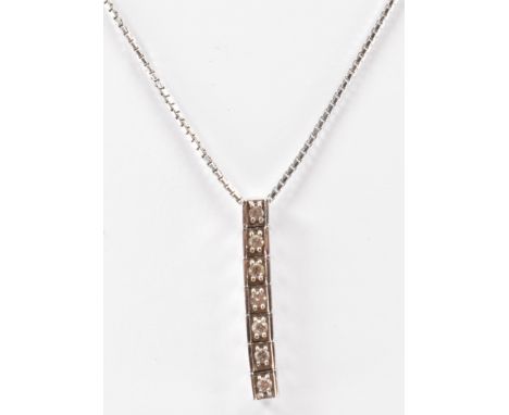 An 18ct white gold and diamond pendant necklace. The necklace strung with a diamond set bar to fine trace chain. Hallmarked 1