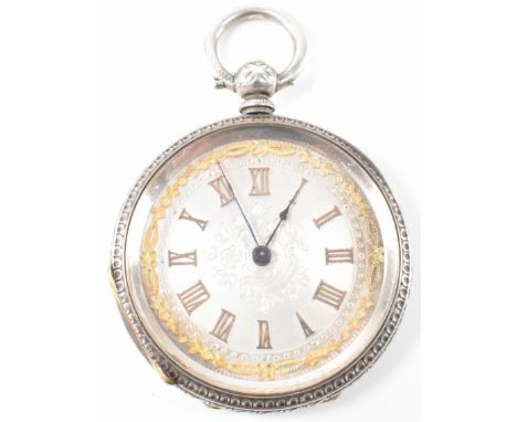 A silver pocket fob watch having arabic numerals to the chapter ring, gilt detailing, an engraved case and round bale to the 