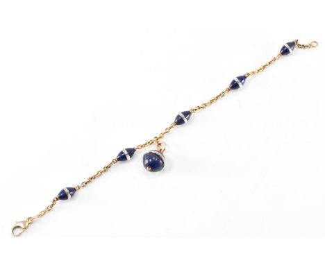 A vintage gold,&nbsp; lapis lazuli and rock crystal bracelet. The bracelet having an oval link chain having threaded lapis la